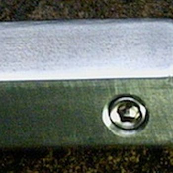 Put a flat spot on a cylindrical shaft to attach a locking feature