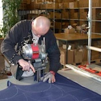 Several layers of cloth are cut at the same time